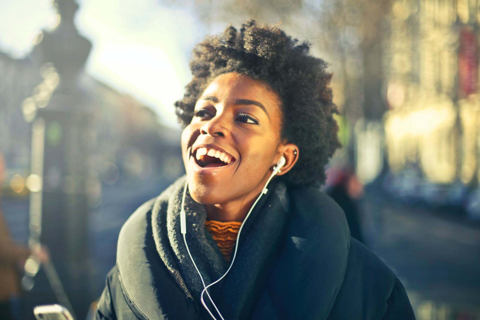 close up photo of a woman listening to music