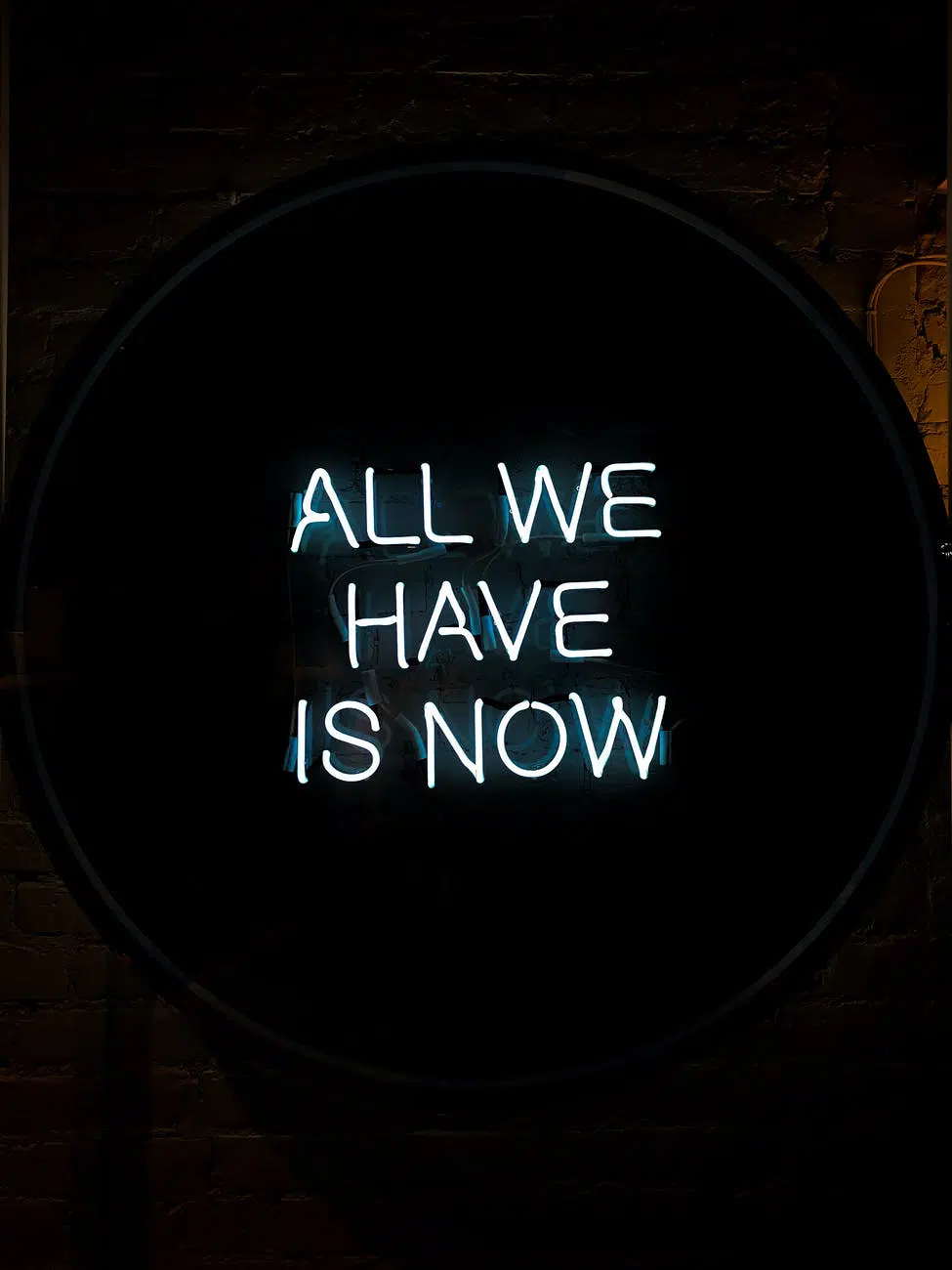 all we have is now neon signage on black surface