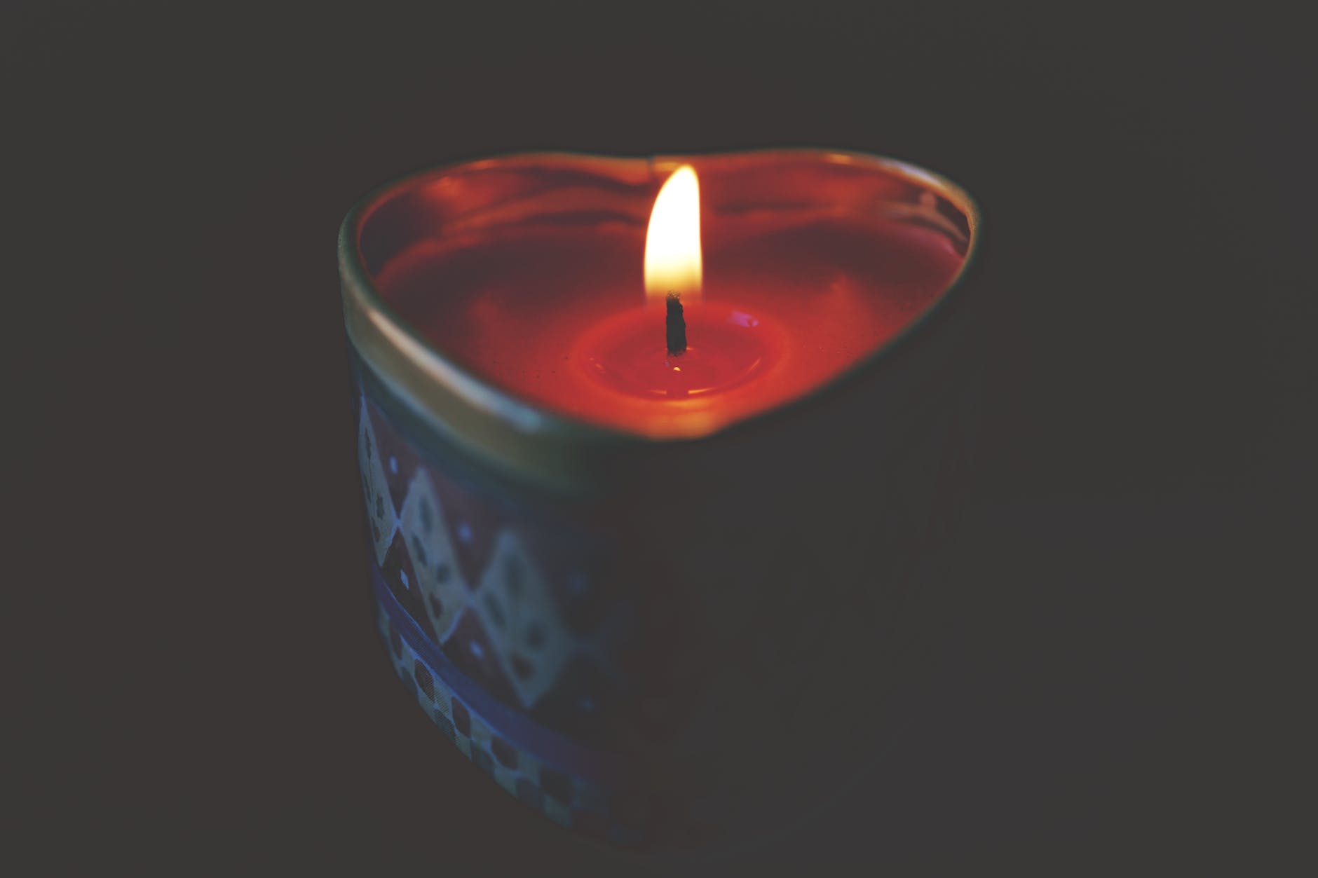 close up of tea light candle against black background