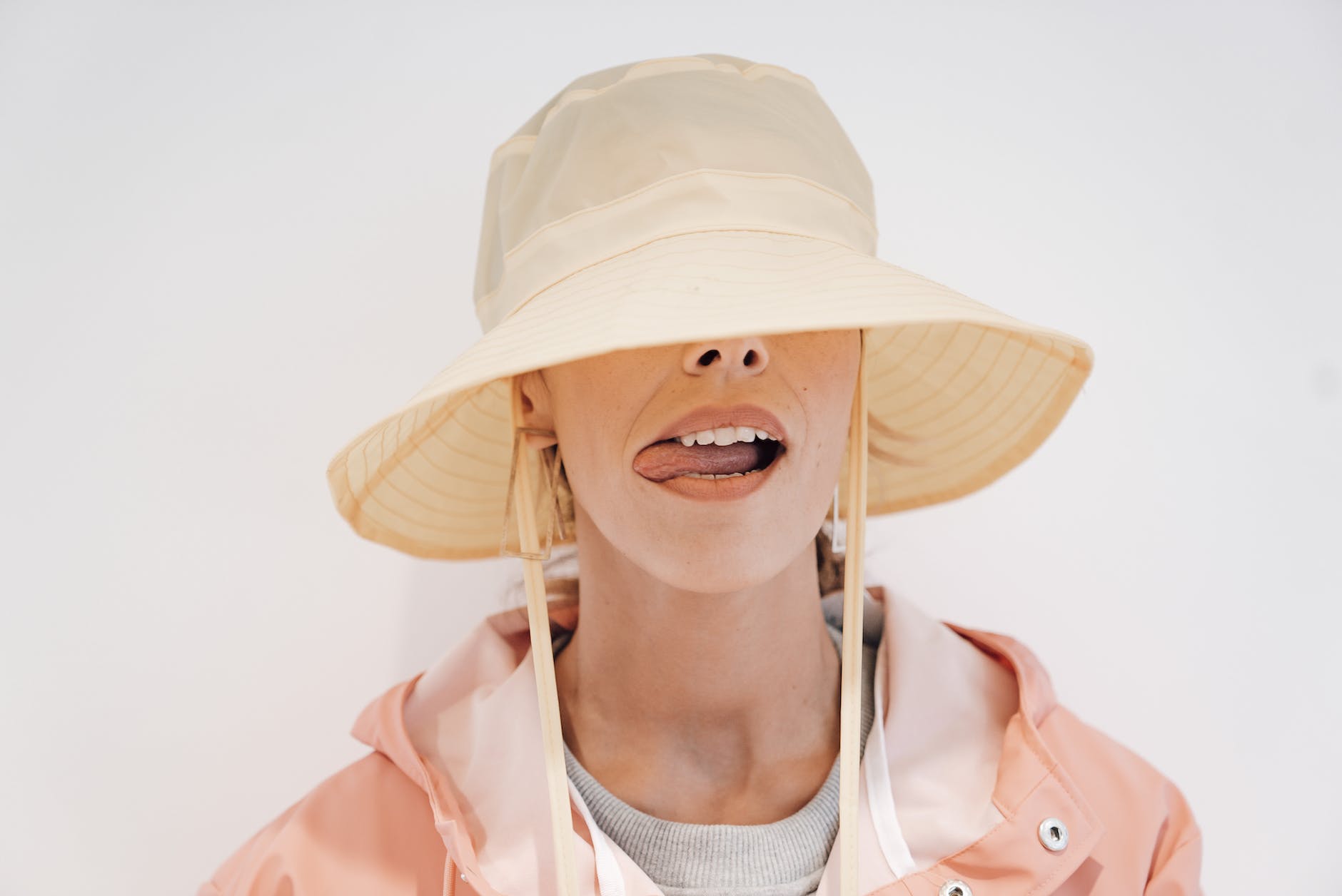 stylish woman in hat with tongue out